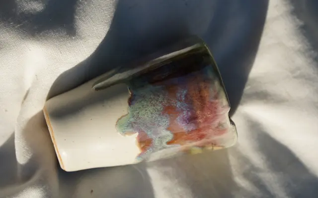 Drip-glazed cup on its side